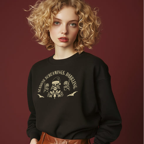 Christmas sweatshirt with "SEASONS SCREAMINGS, DARKLING" text arched over a skull wearing Santa hat. Bats, flowers, and ornate designs surround the skull in vintage-inspired style.